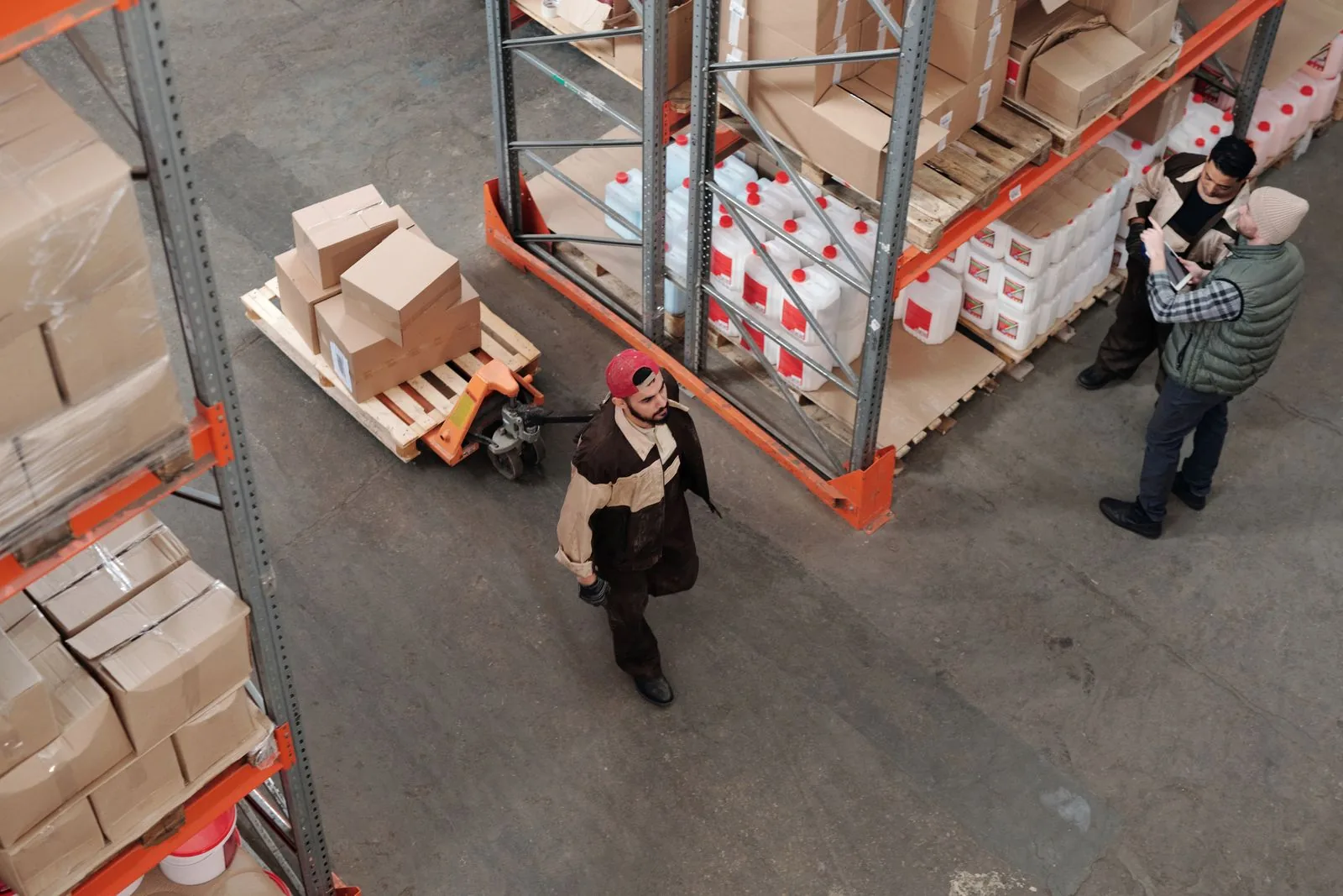 Team checking inventory beside racks of packed goods in our fulfillment warehouse