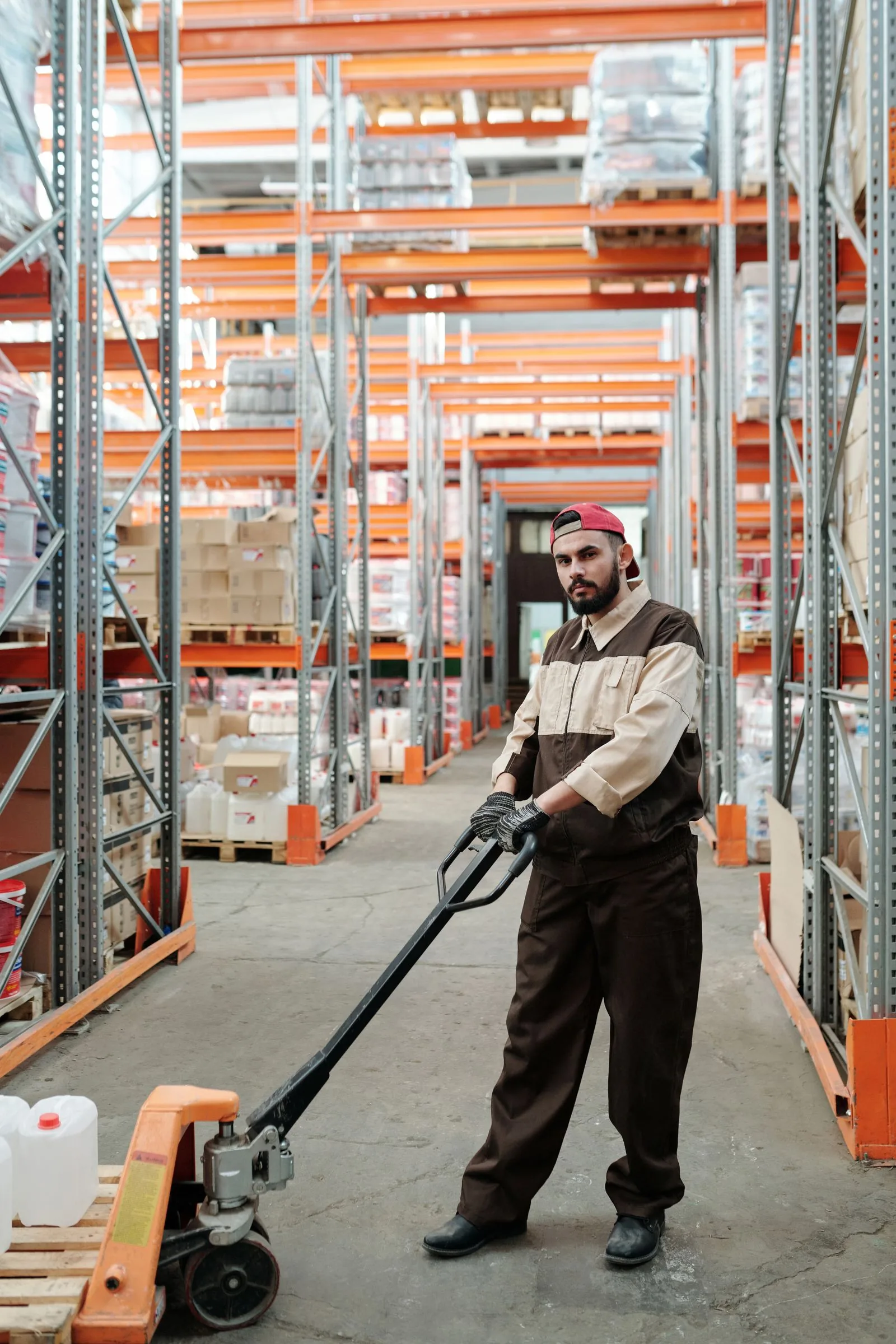 Warehouse team member moving inventory with a pallet jack
