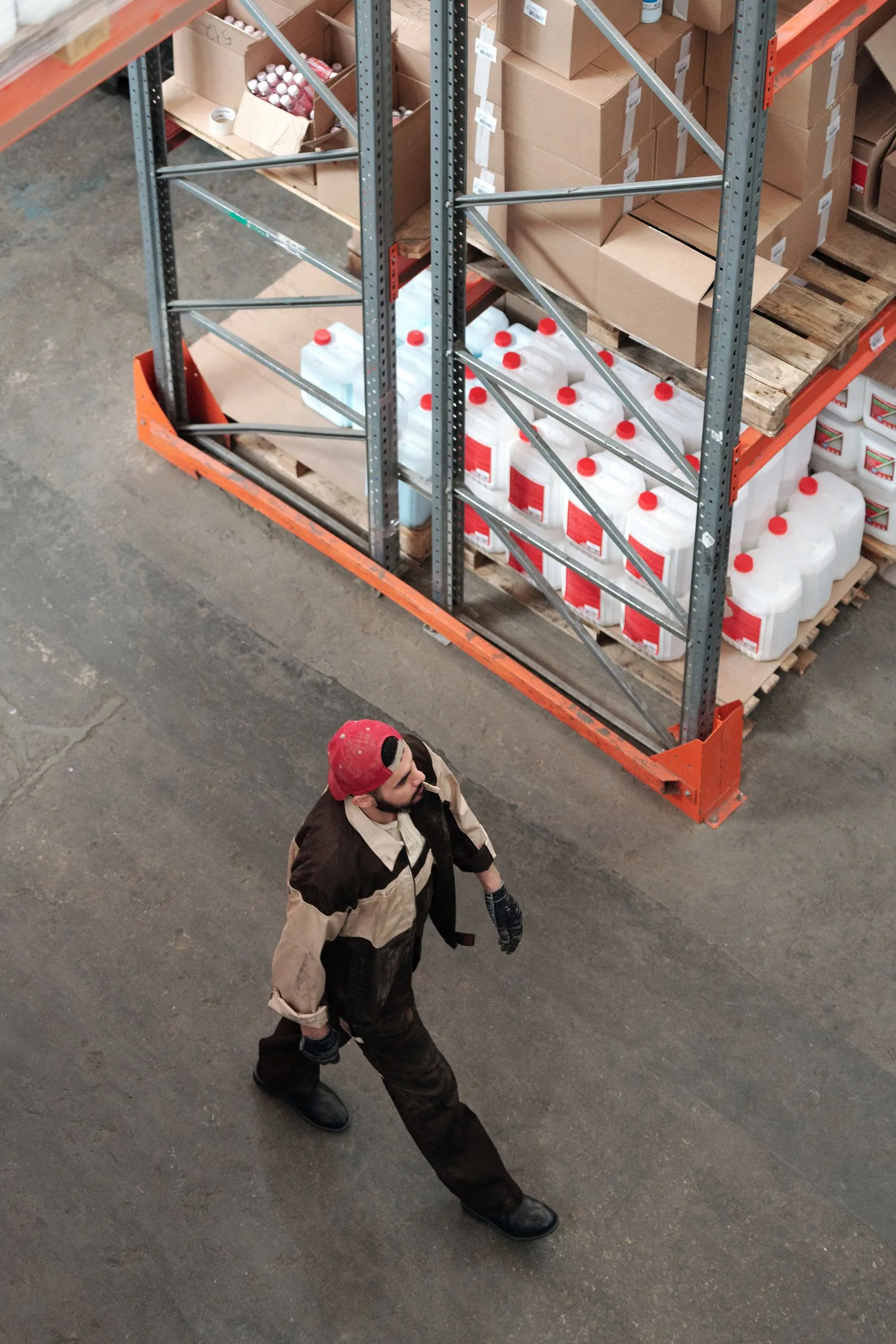 Worker checking shelves of cartons during FBA prep