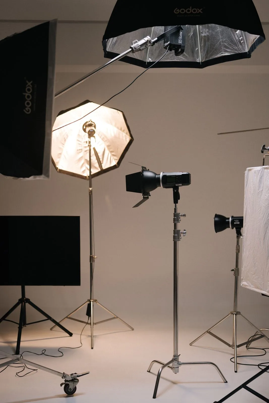 Studio lighting rigs set up for a product photography session