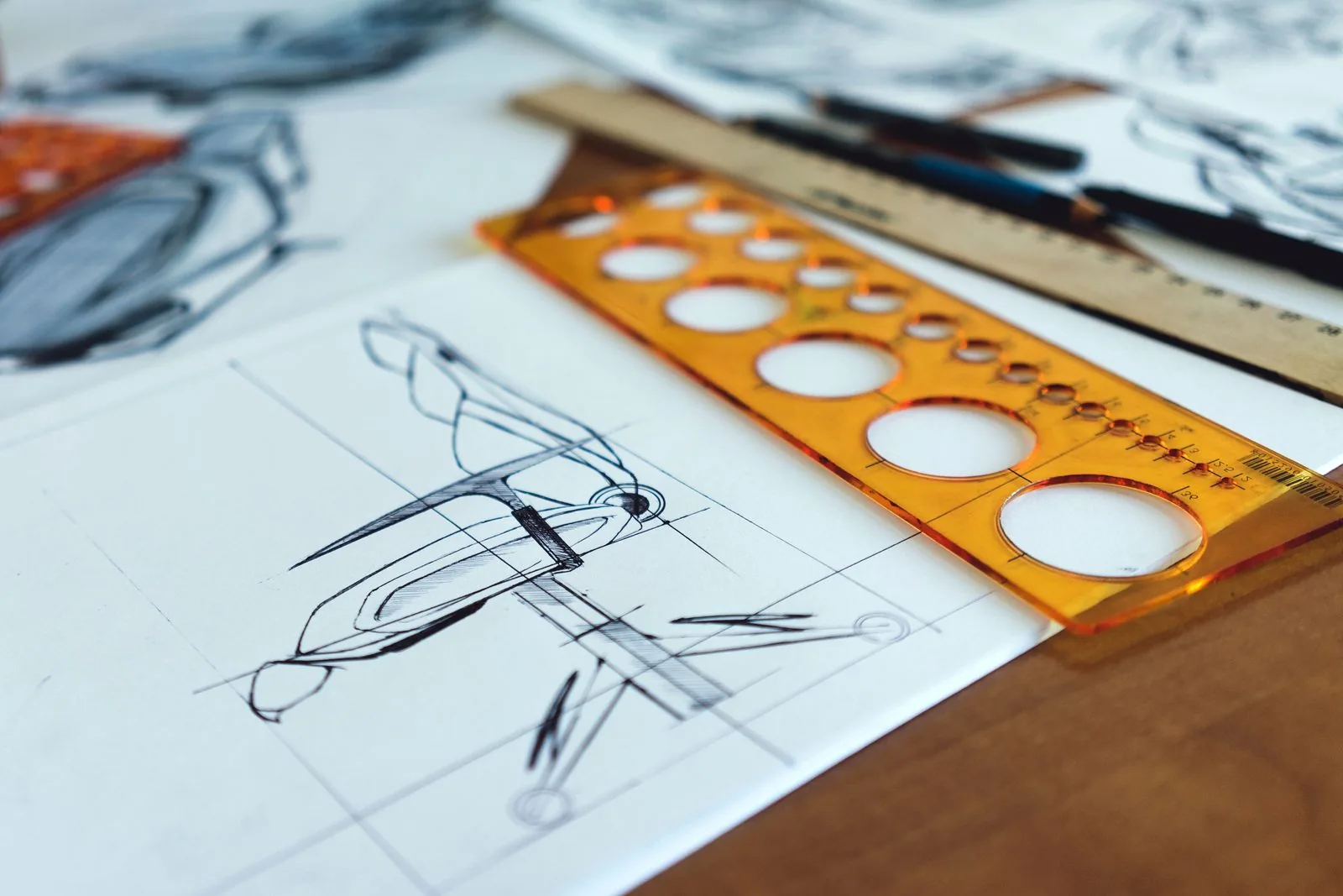 Product concept sketches drawn with an orange circle template ruler