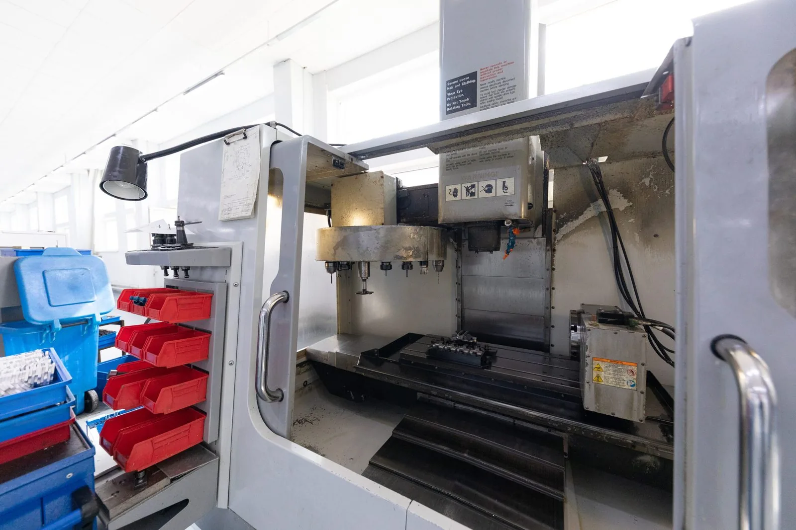 CNC machining center set up inside a manufacturing workshop