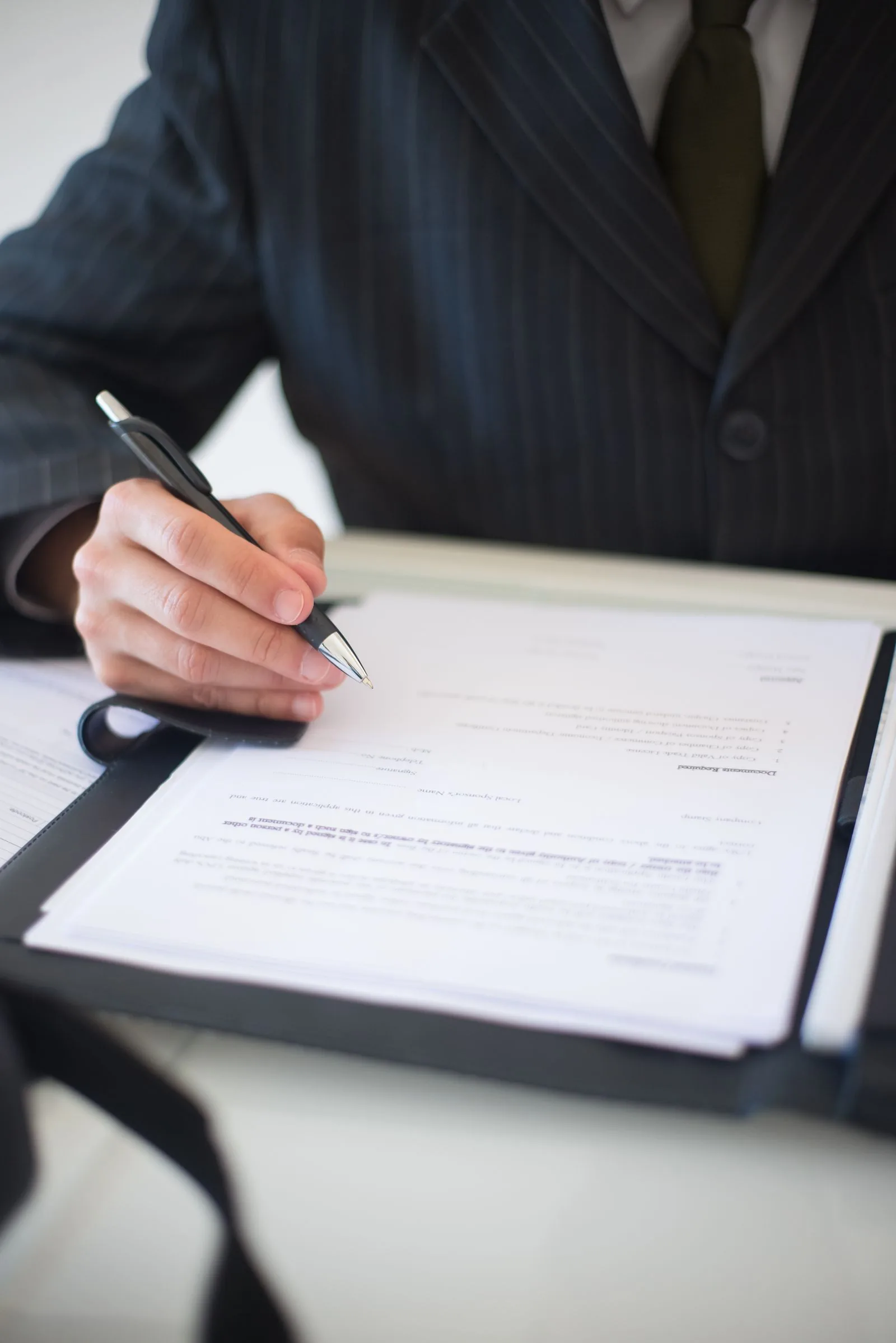 Business professional signing procurement documents